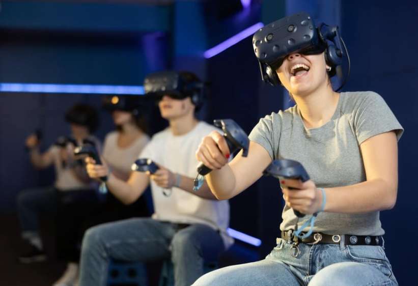 A family wearing VR headsets at a virtual gaming centre.