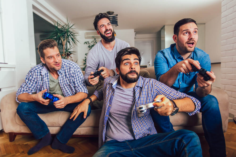 A group of men playing video games at a buck’s night.